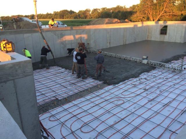 Lux Concrete, Inc. pouring and screeding concrete over the Pex Tubing.